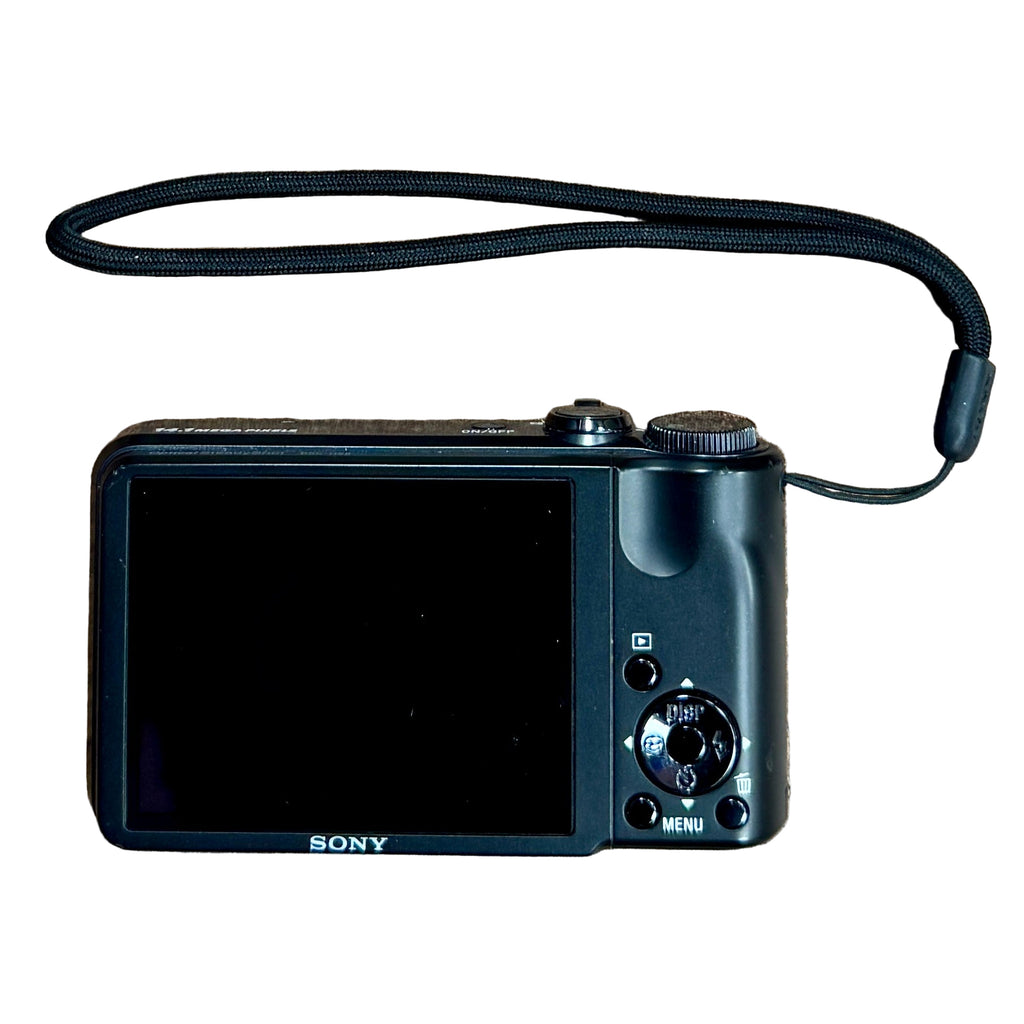 Sony Cyber-Shot DSC-H55 14.1MP Digital Camera w/ Case - Black Sony camera with a strap on a wooden surface