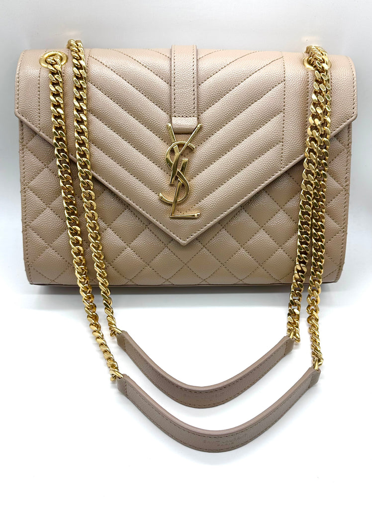 Beige handbag with gold chain strap on a white background