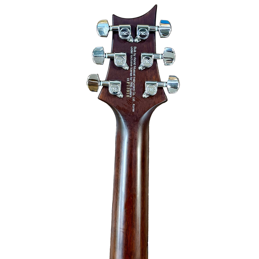 PRS Paul Reed Smith SE Standard Electric Guitar Close-up of a guitar headstock with tuning pegs on a white background