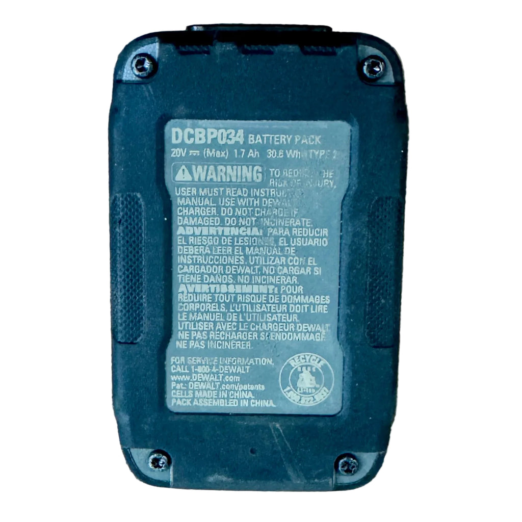 DeWalt 20V MAX POWERSTACK 1.7Ah Lithium Ion Compact Battery Pack (DCBP034) Black battery pack with warning label on a wooden surface
