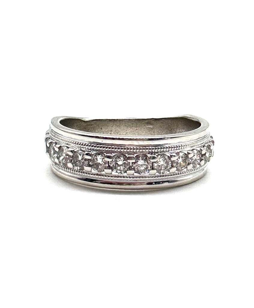 Silver ring with diamond accents on a white background