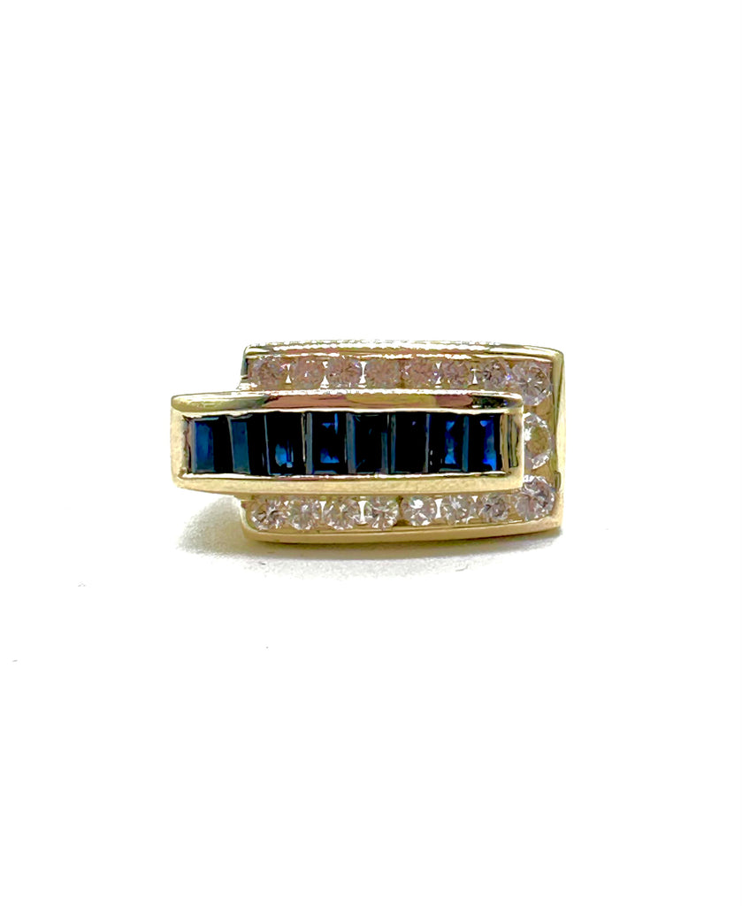 Gold ring with blue gemstones and diamonds on a white background