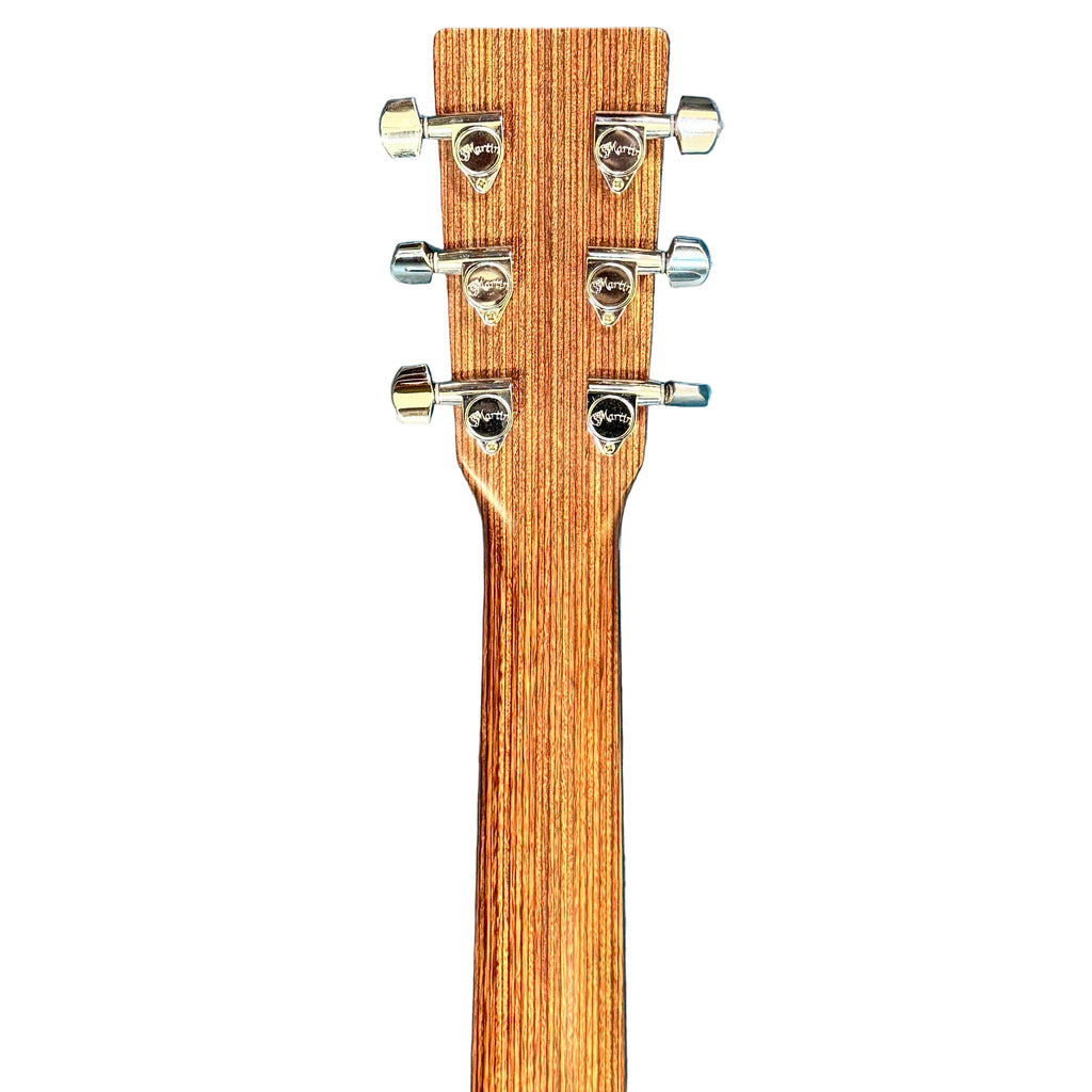 Martin X Series Special Acoustic-Electric Guitar w/ Soft Case Wooden guitar neck with tuning pegs on a blue surface