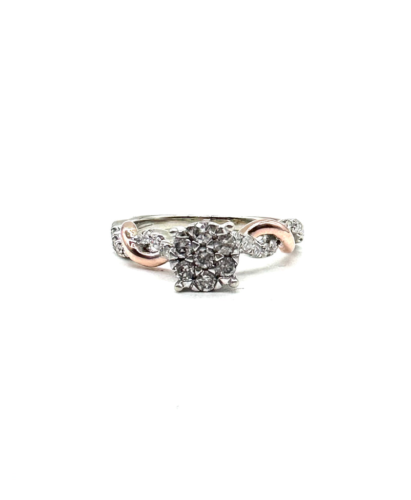 Diamond ring with rose gold and silver band on a white background