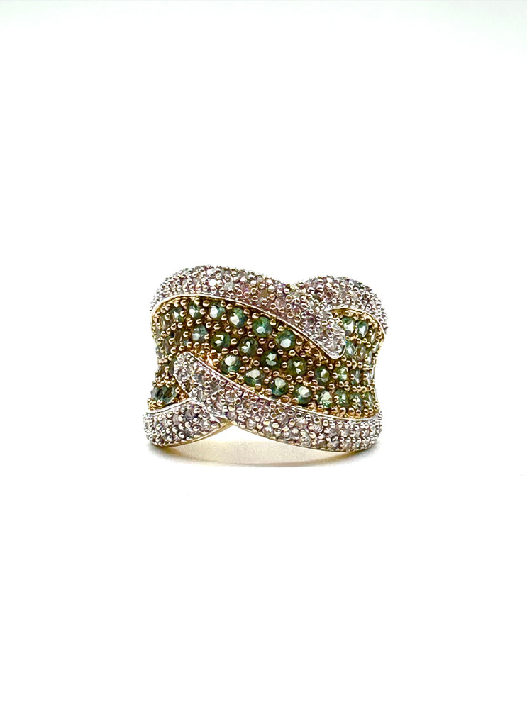 Elegant ring with green gemstones and diamond accents on a white background