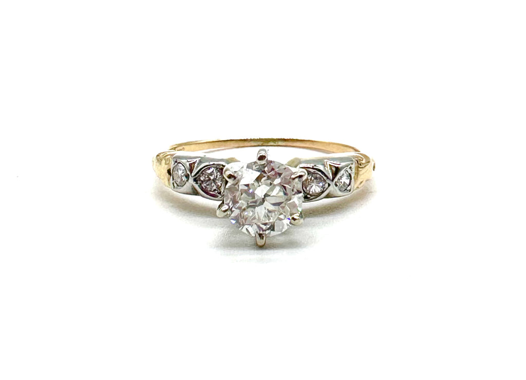 Diamond ring with gold and silver band on a white background