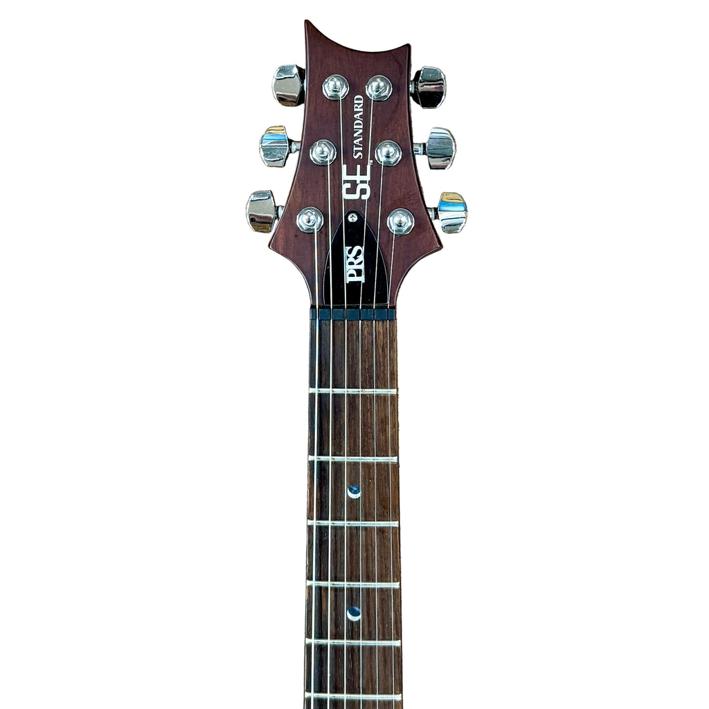 PRS Paul Reed Smith SE Standard Electric Guitar  headstock with tuning pegs on a wooden surface