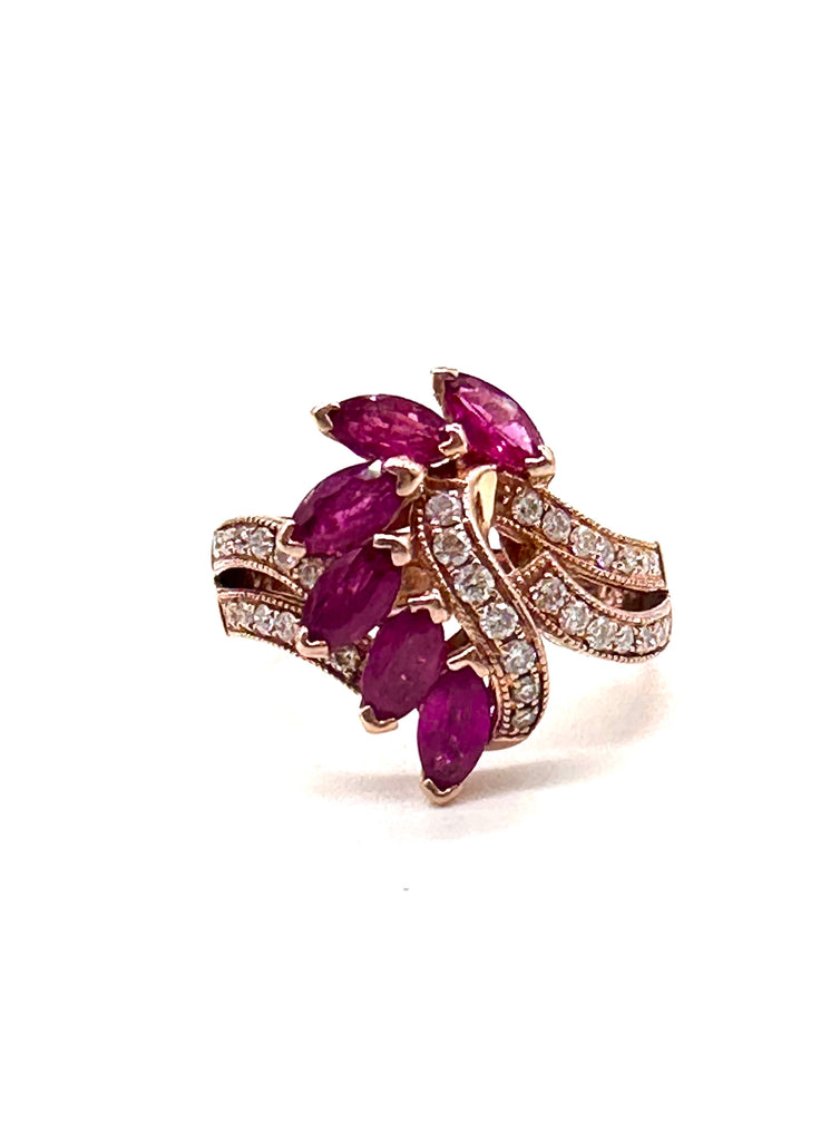 Rose gold ring with purple gemstones on a white background