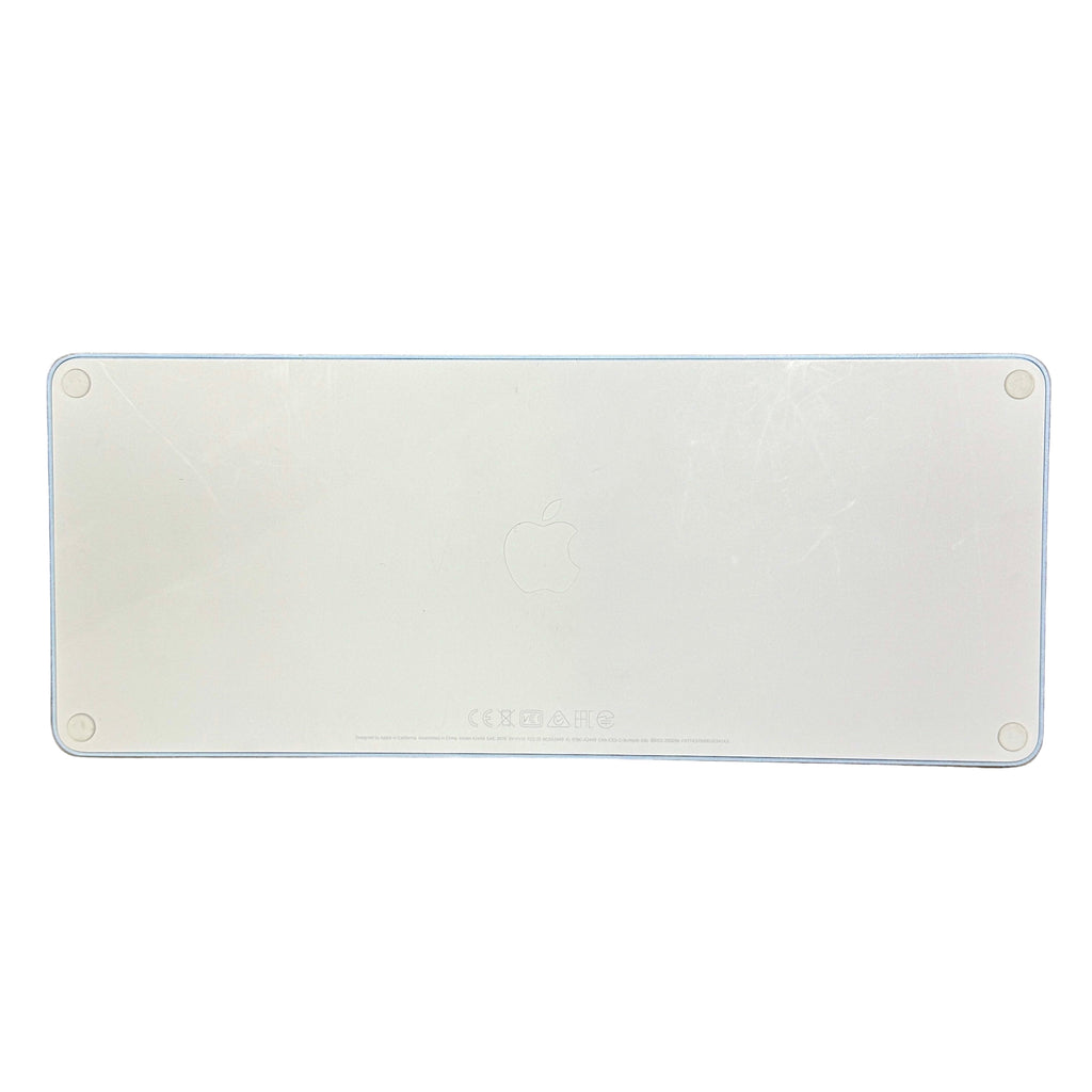 Apple Magic Keyboard with Touch ID for Mac Models with Apple Silicon - USB-C - Blue (A2449) White rectangular metal plate with 'Caterpillar' branding on a wooden surface