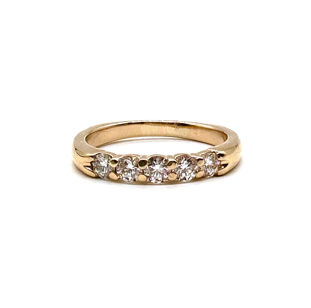 Gold ring with three diamonds on a white background