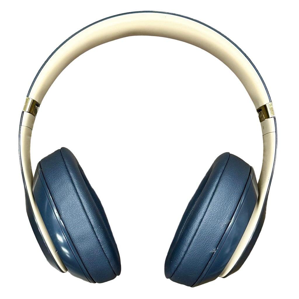 Apple Beats Studio3 Wireless Noise Cancelling Headphones - Shadow Gray Blue headphones with beige headband on a wooden surface