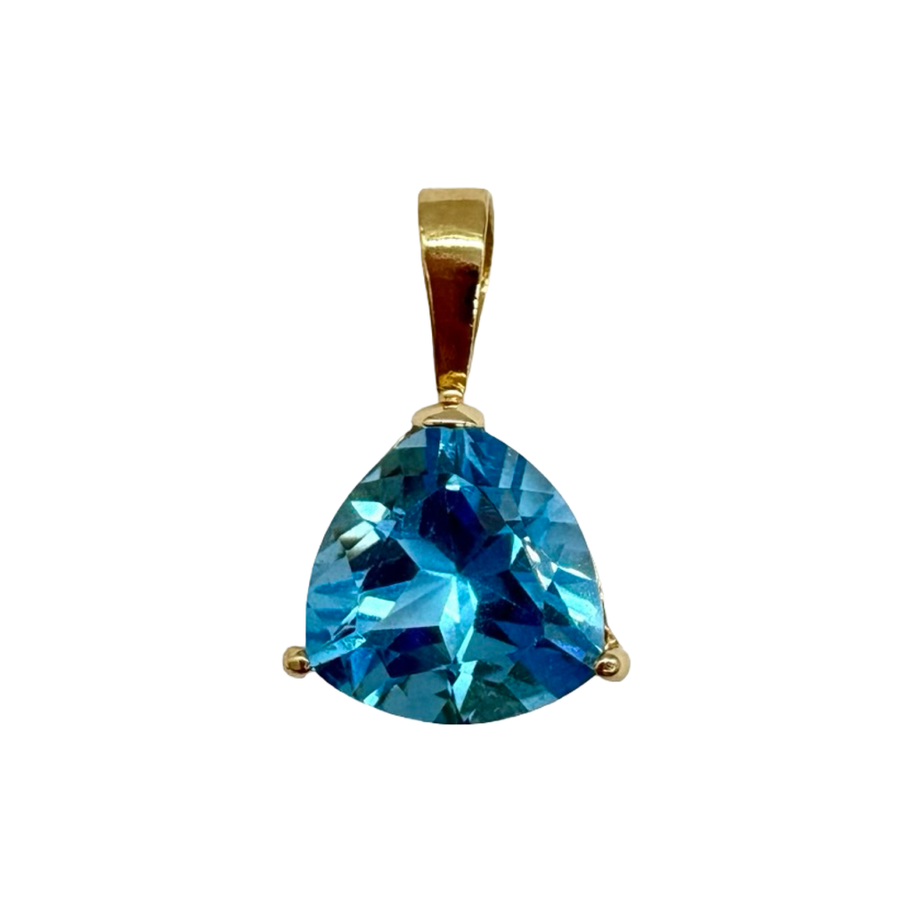Gold pendant with a large blue gemstone on a white background