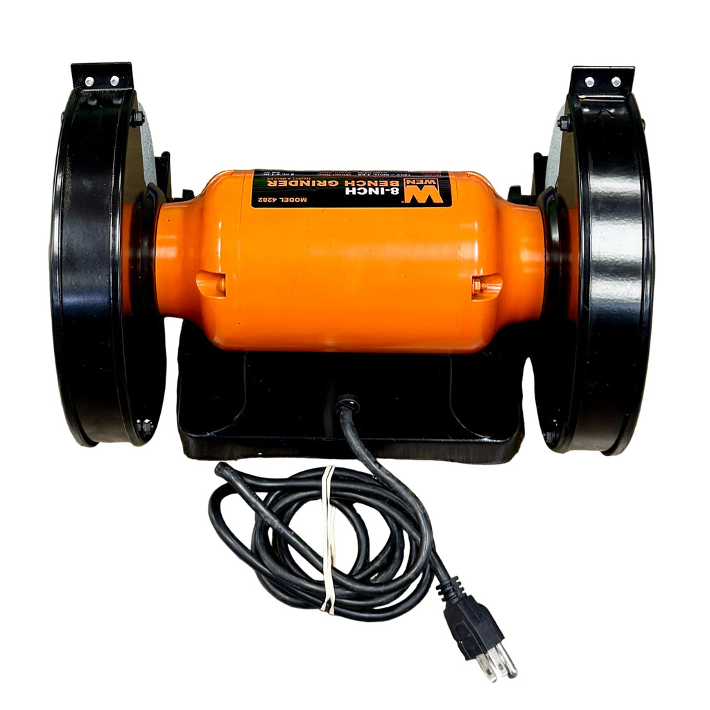 WEN 4.8-Amp 8" Bench Grinder (4282) Orange and black grinder on a wooden floor with power cord attached