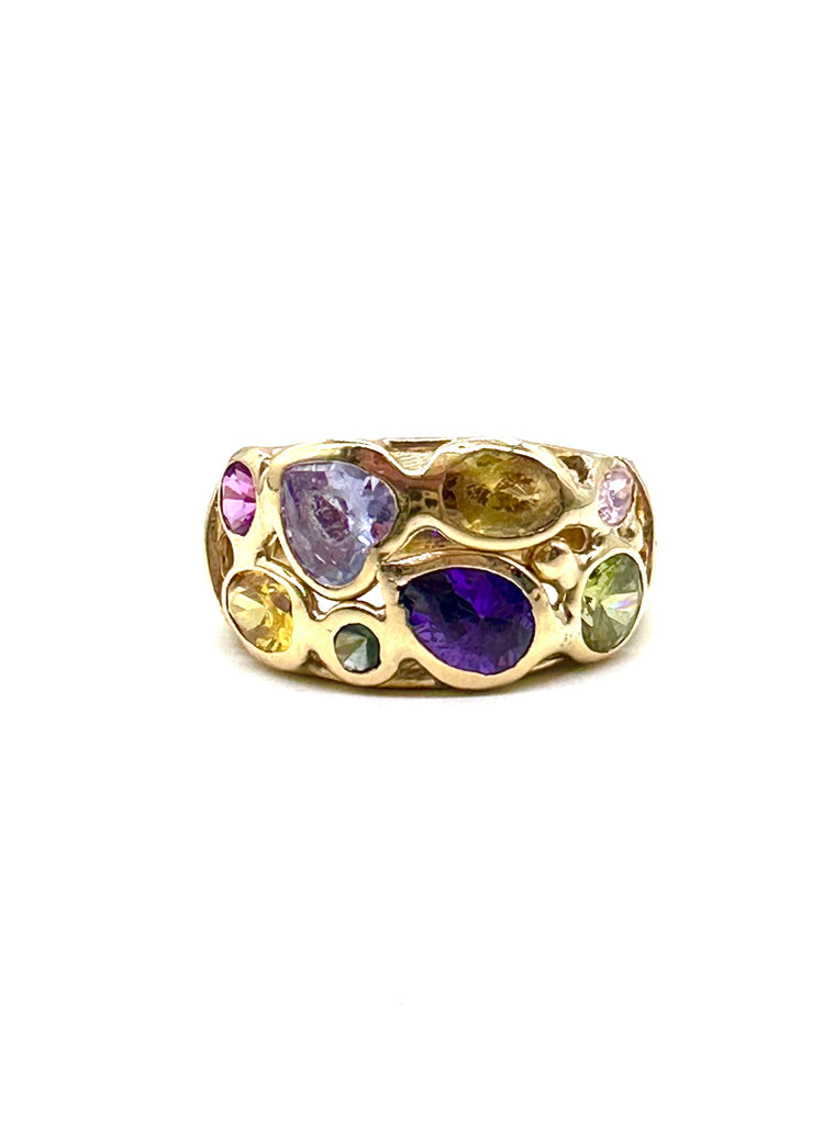 Gold ring with multicolored gemstones on a white background