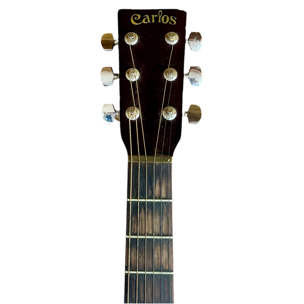 Carlos Model No. 249 Acoustic Guitar Close-up of a guitar headstock with 'Carlos' branding on a white background