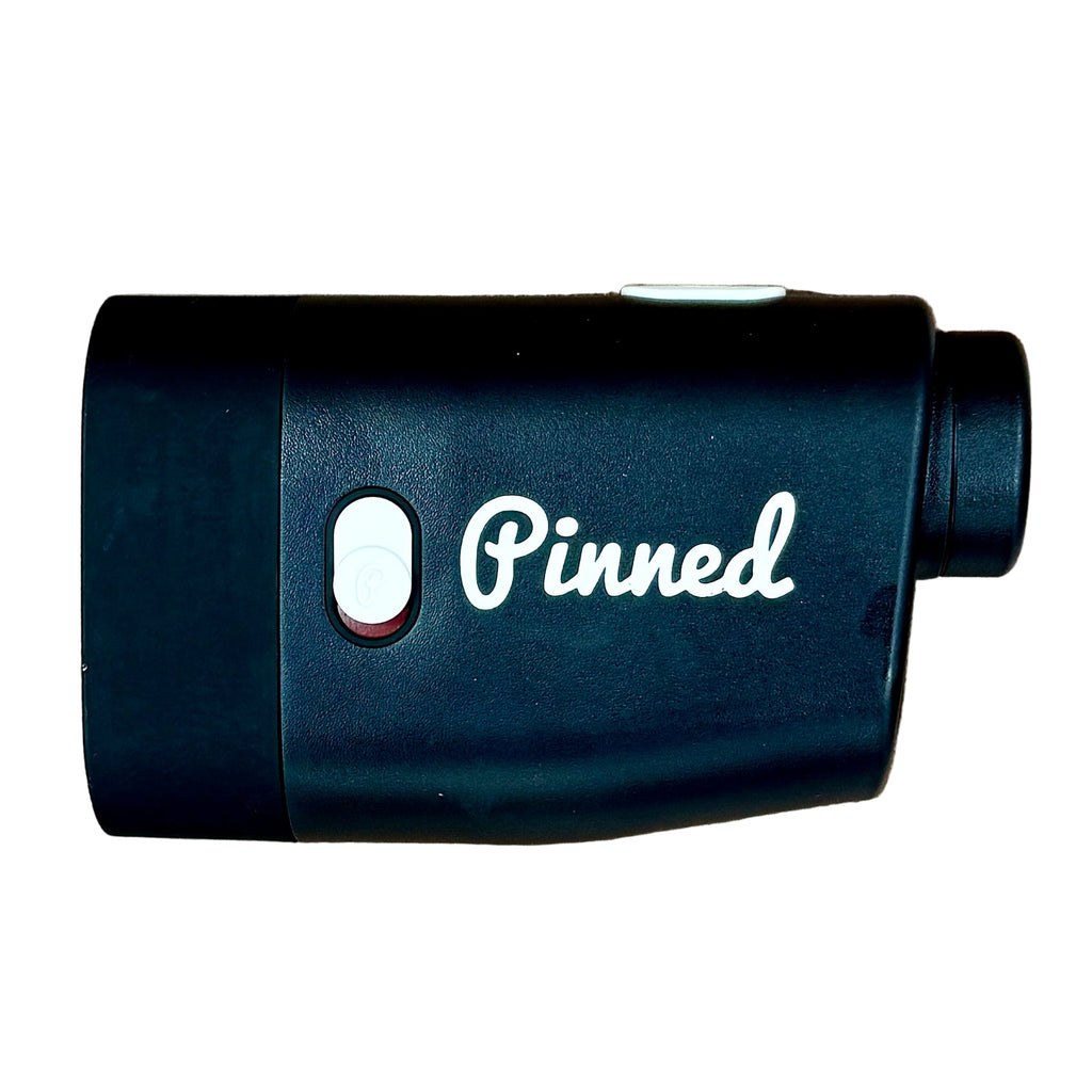 Pinned PRISM+ Laser Golf Rangefinder w/ Slope - Black device with 'Pinned' logo on a wooden surface