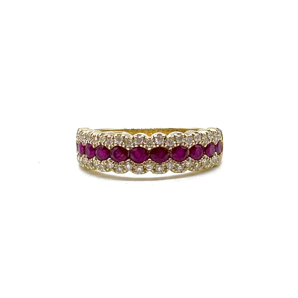 Gold ring with red gemstones and clear stones on a white background