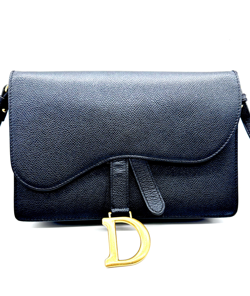 Black handbag with a gold 'D' emblem on a white background