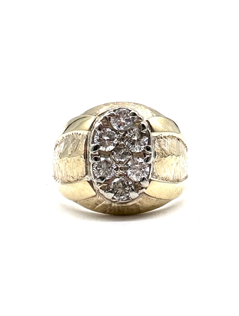 Gold ring with diamond cluster on a white background