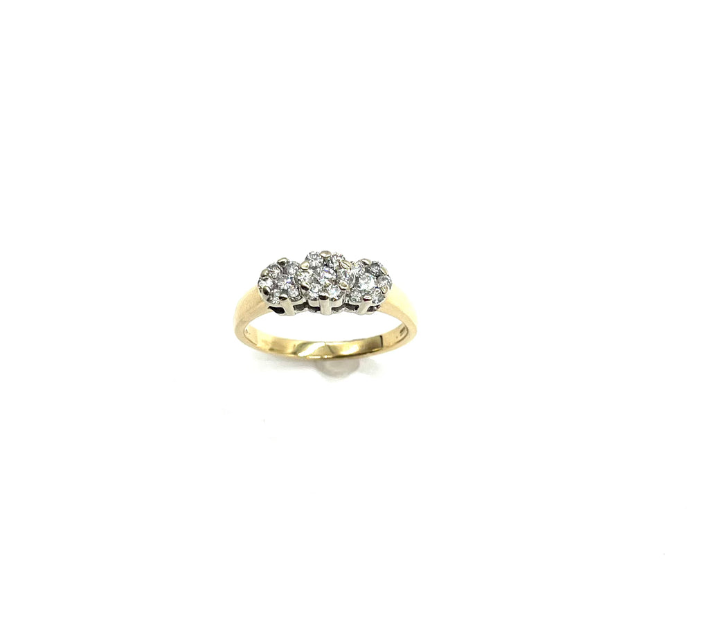 Gold ring with a diamond cluster on a white background