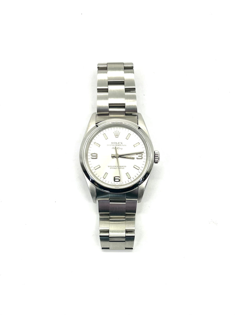 Silver watch with a white face on a white background