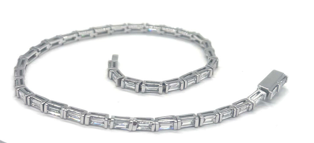 Silver bracelet with rectangular gemstones on a white background