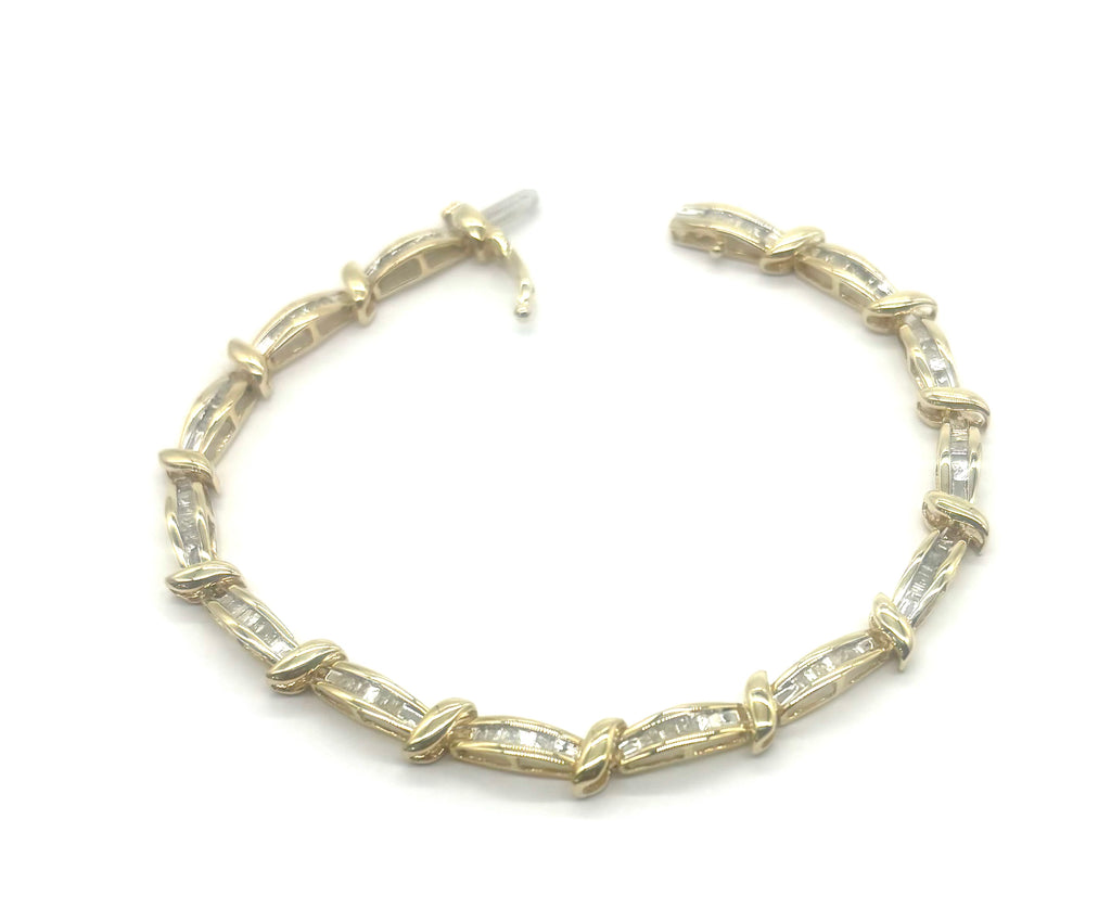 Gold bracelet with clear stones on a white background