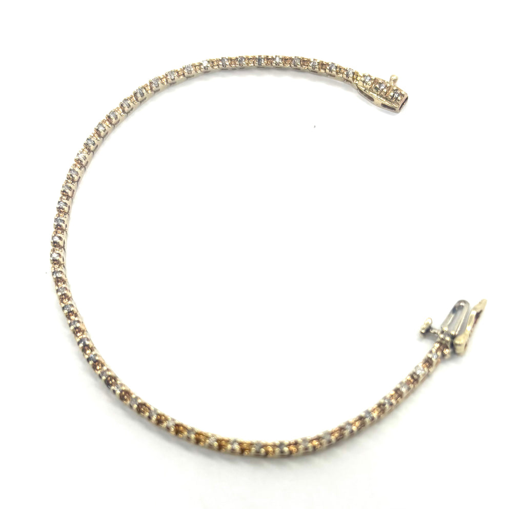 Gold bracelet with clear stones on a white background