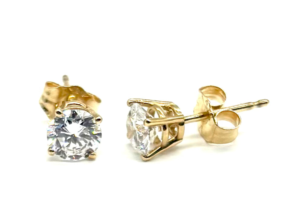 Gold stud earrings with clear gemstones on a white background