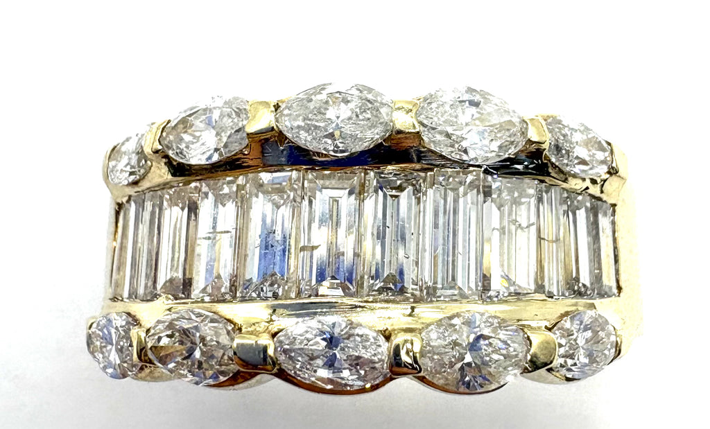 Diamond ring with various cut diamonds on a white background