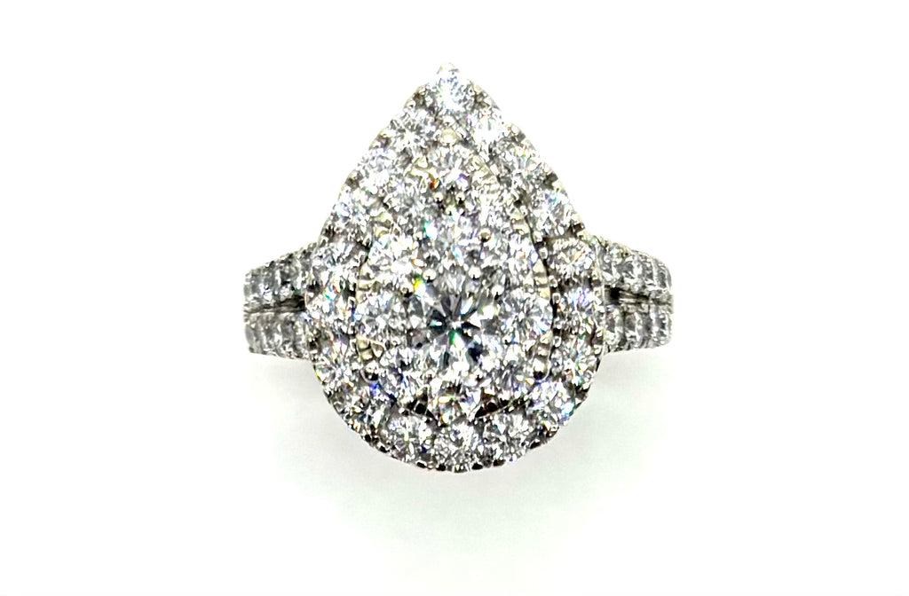 Diamond ring with a pear-shaped center stone on a white background