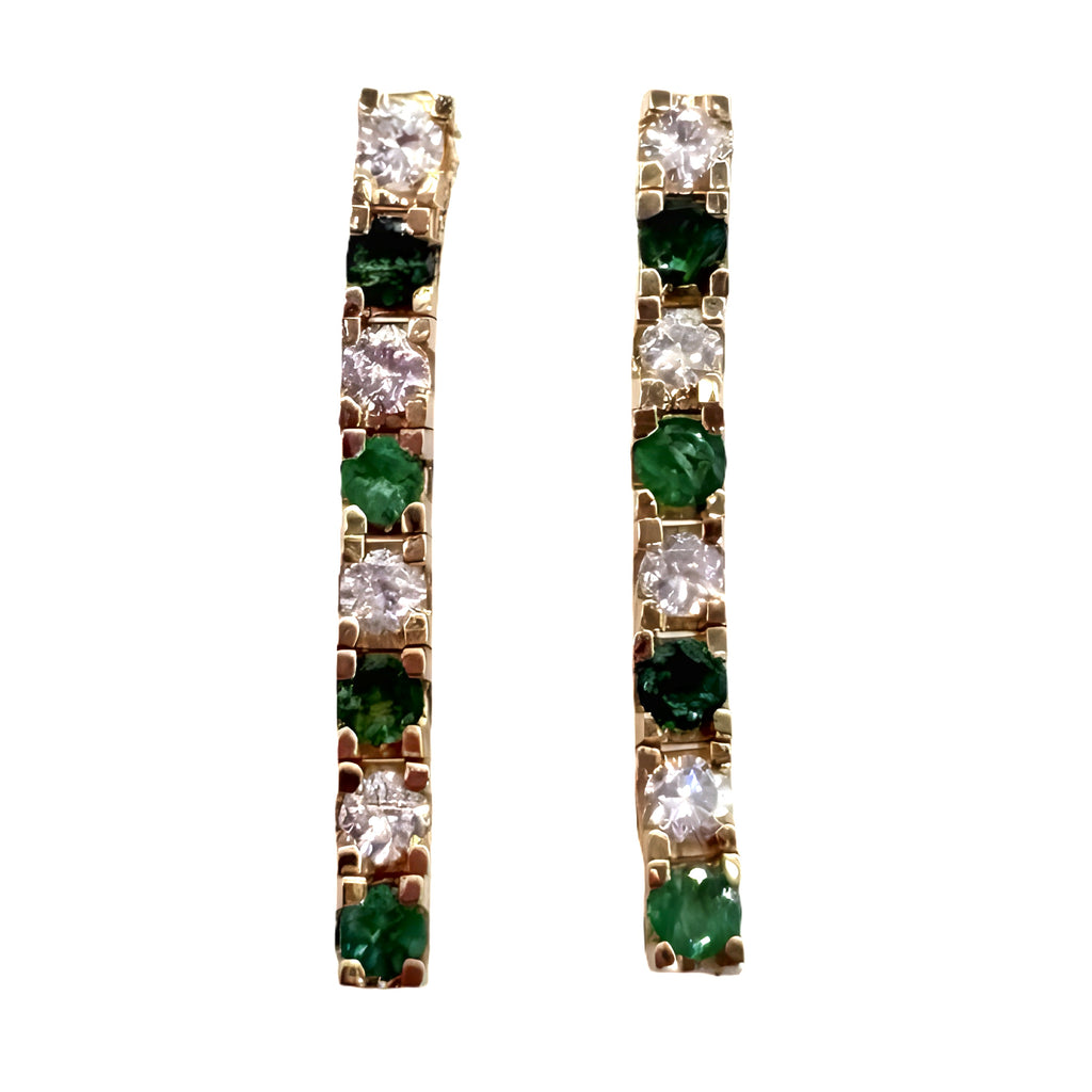 Pair of gold earrings with green gemstones on a white background