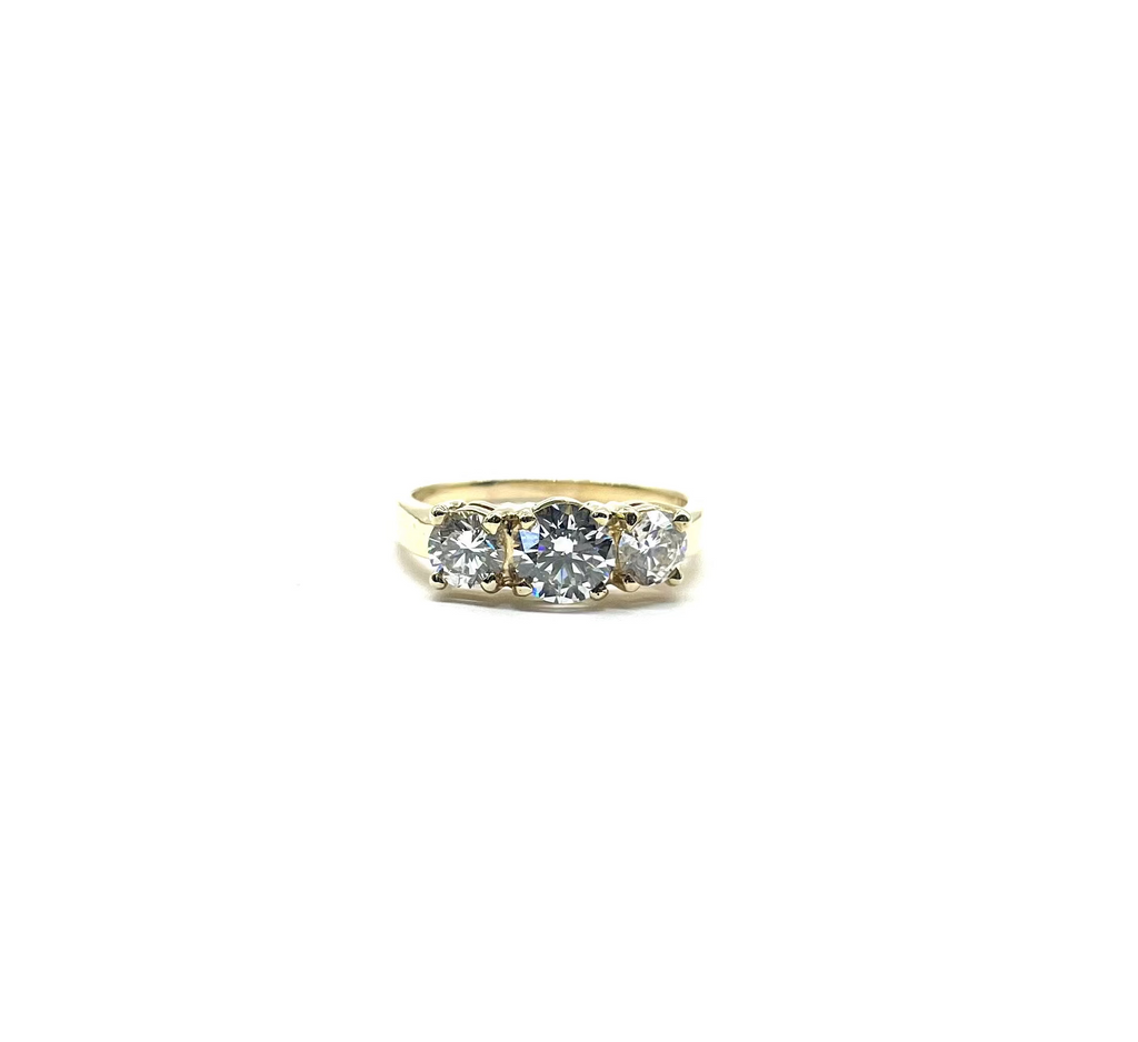 Gold ring with three diamonds on a white background