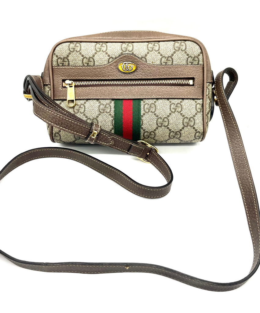 Gucci handbag with monogram pattern and iconic logo on a white background