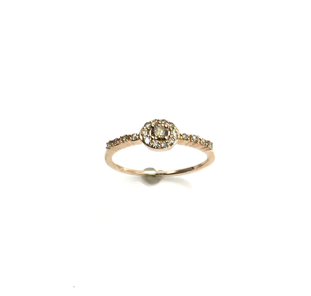 Gold ring with a central diamond and smaller diamonds on a white background