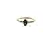 Gold ring with a blue gemstone and bead accents on a white background
