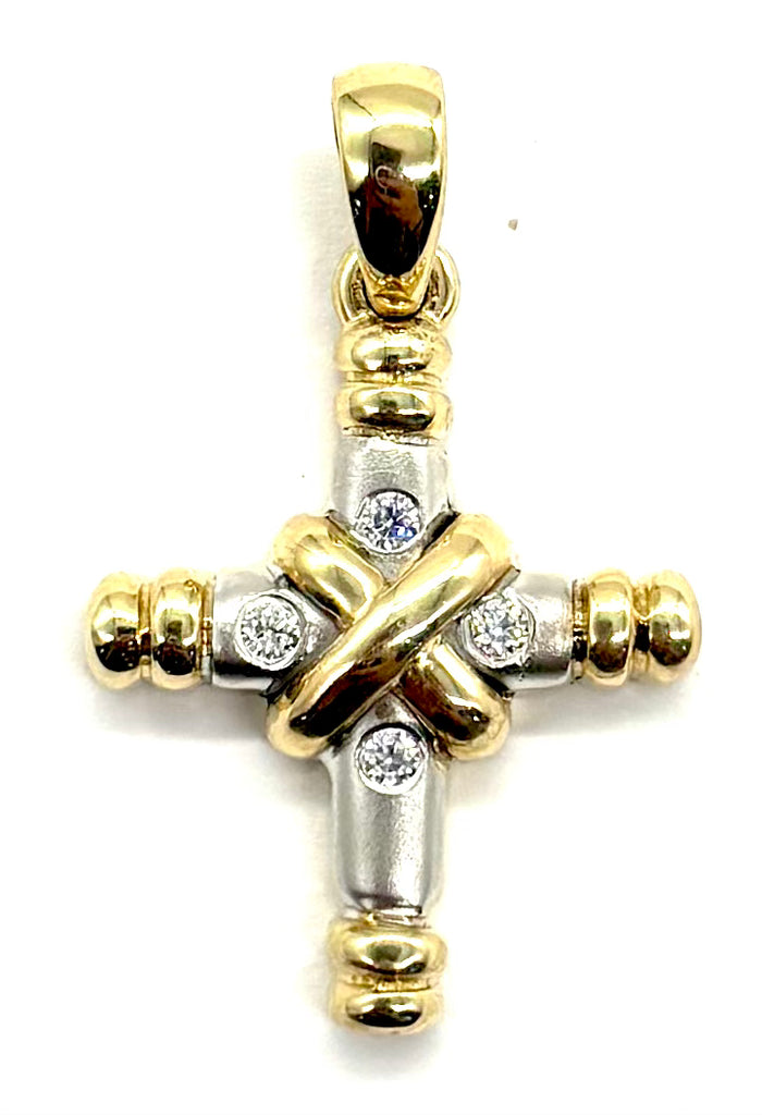 Gold and silver cross pendant with embedded diamonds on a white background
