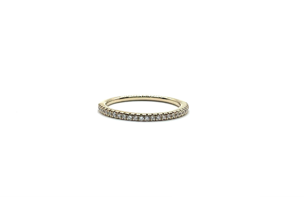 Gold ring with small diamonds on a white background