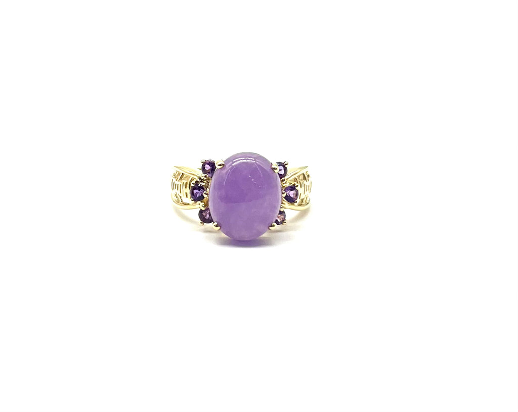 Gold ring with a purple gemstone on a white background