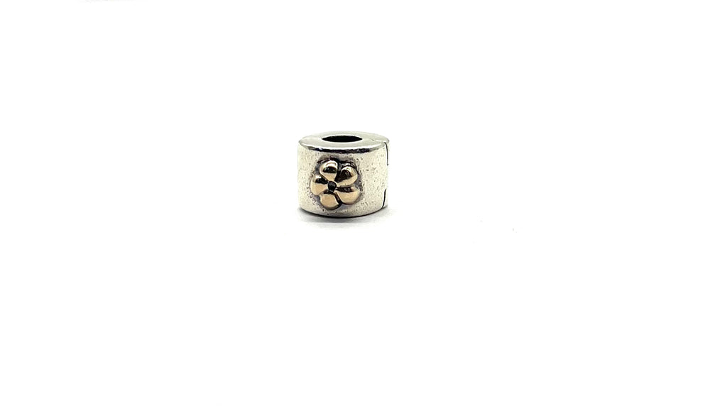 Silver beaded charm with floral design on a white background