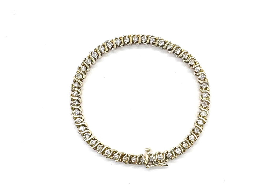 Gold bracelet with diamonds on a white background