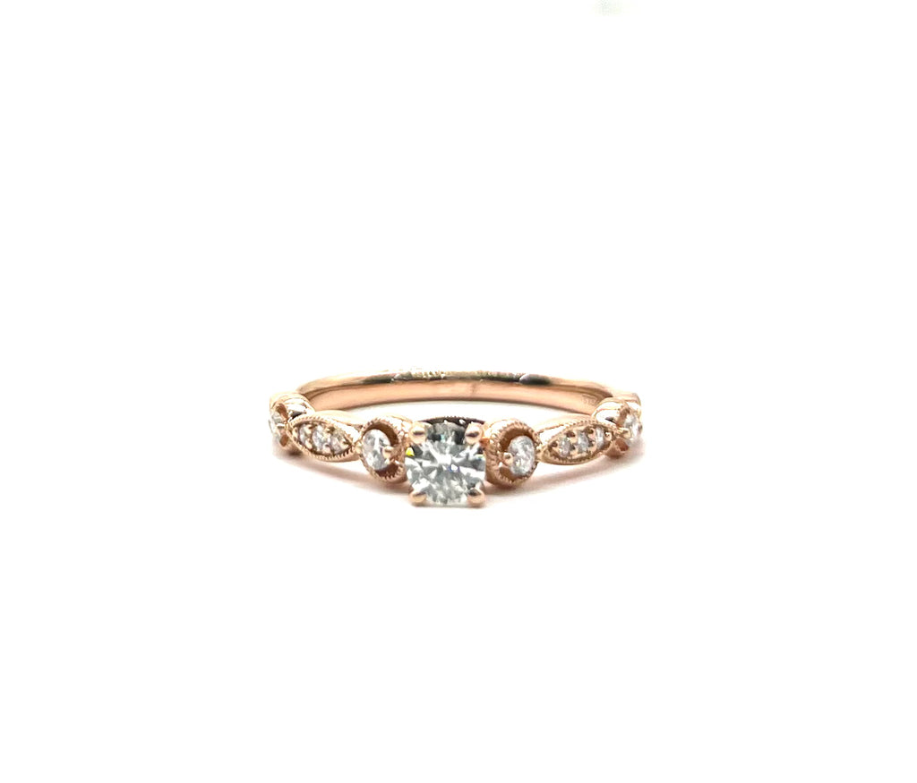 Rose gold ring with a diamond on a white background