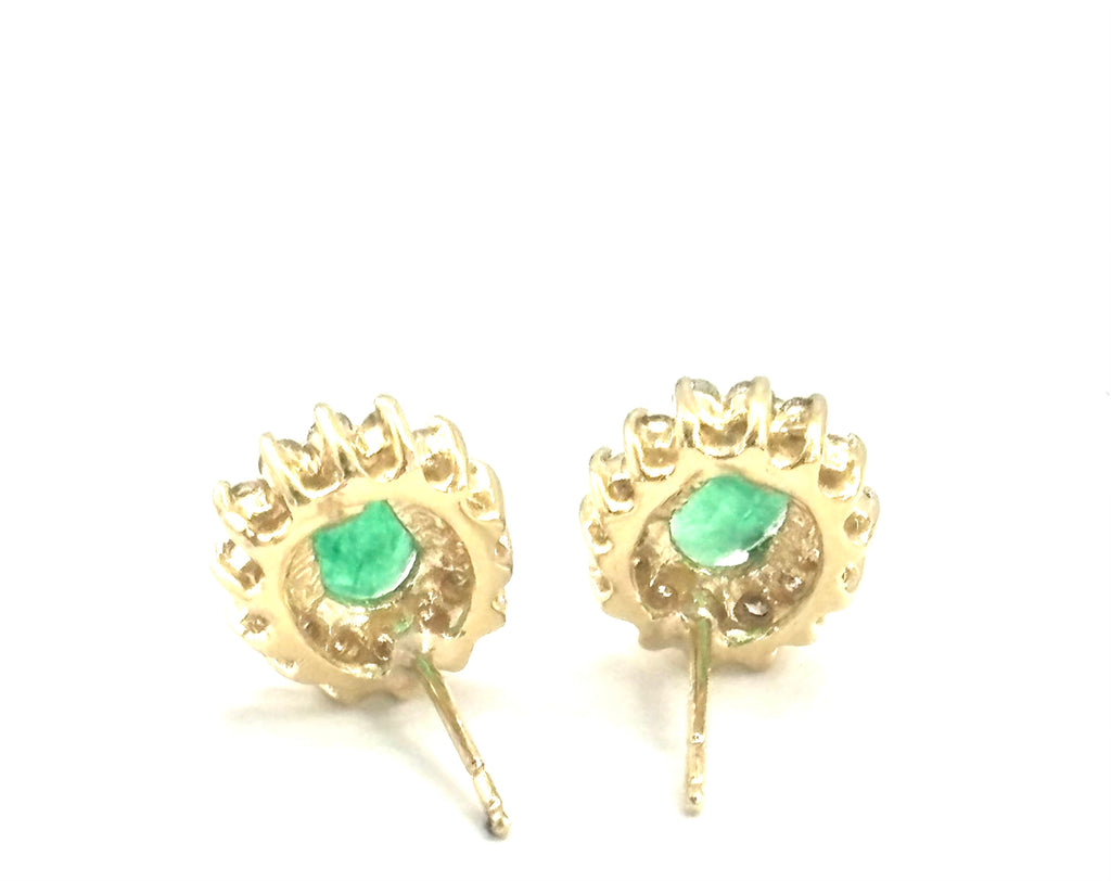 Oval Emerald and Diamond Stud Earrings behind