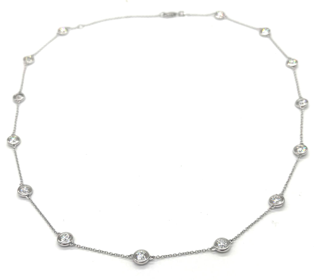 Silver necklace with small round beads on a white background