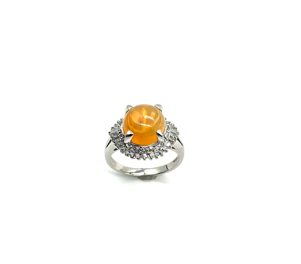 Silver ring with a yellow gemstone on a white background