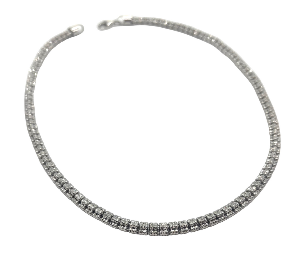 Silver beaded necklace on a white background