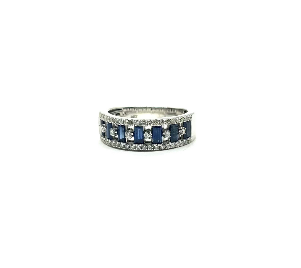 Silver ring with blue gemstones and clear stones on a white background