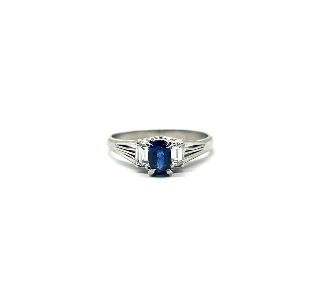 Silver ring with a blue gemstone on a white background