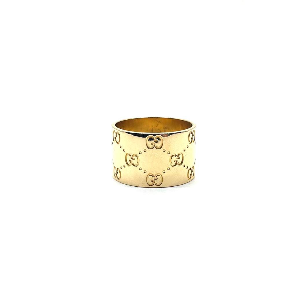 Gold ring with Gucci logo on a white background
