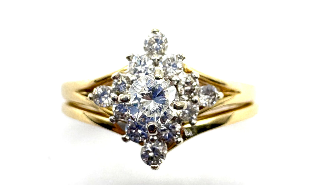 Gold ring with diamond cluster on a white background